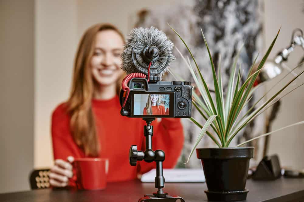 Woman recording herself with a video camera