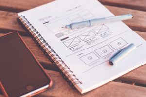 website wireframe drawn on a notebook